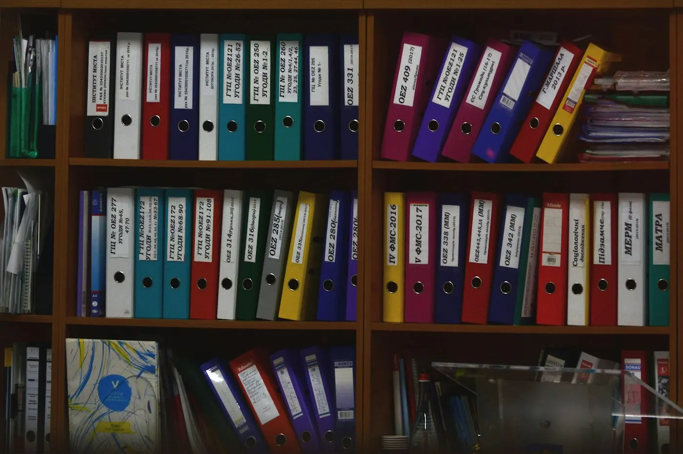 Labeled binders on office shelves