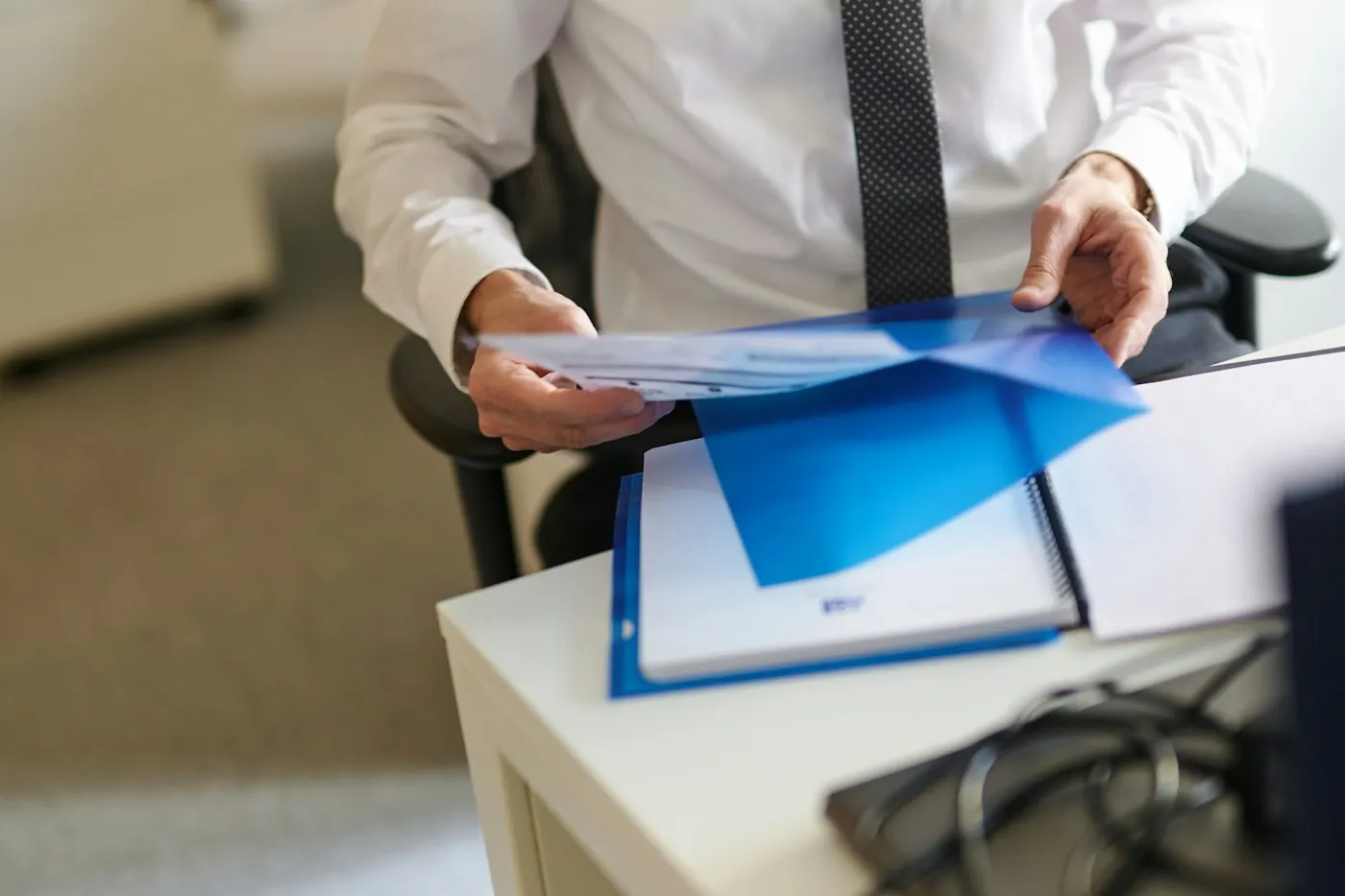A broker reviewing a file at his desk