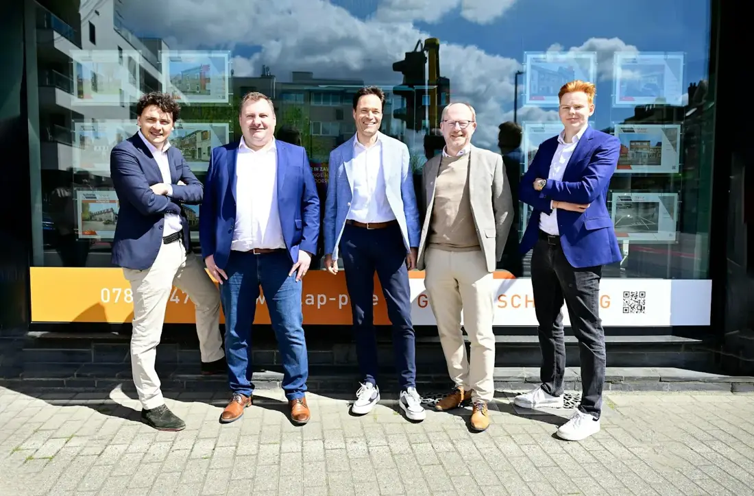 A small real estate team outside their office