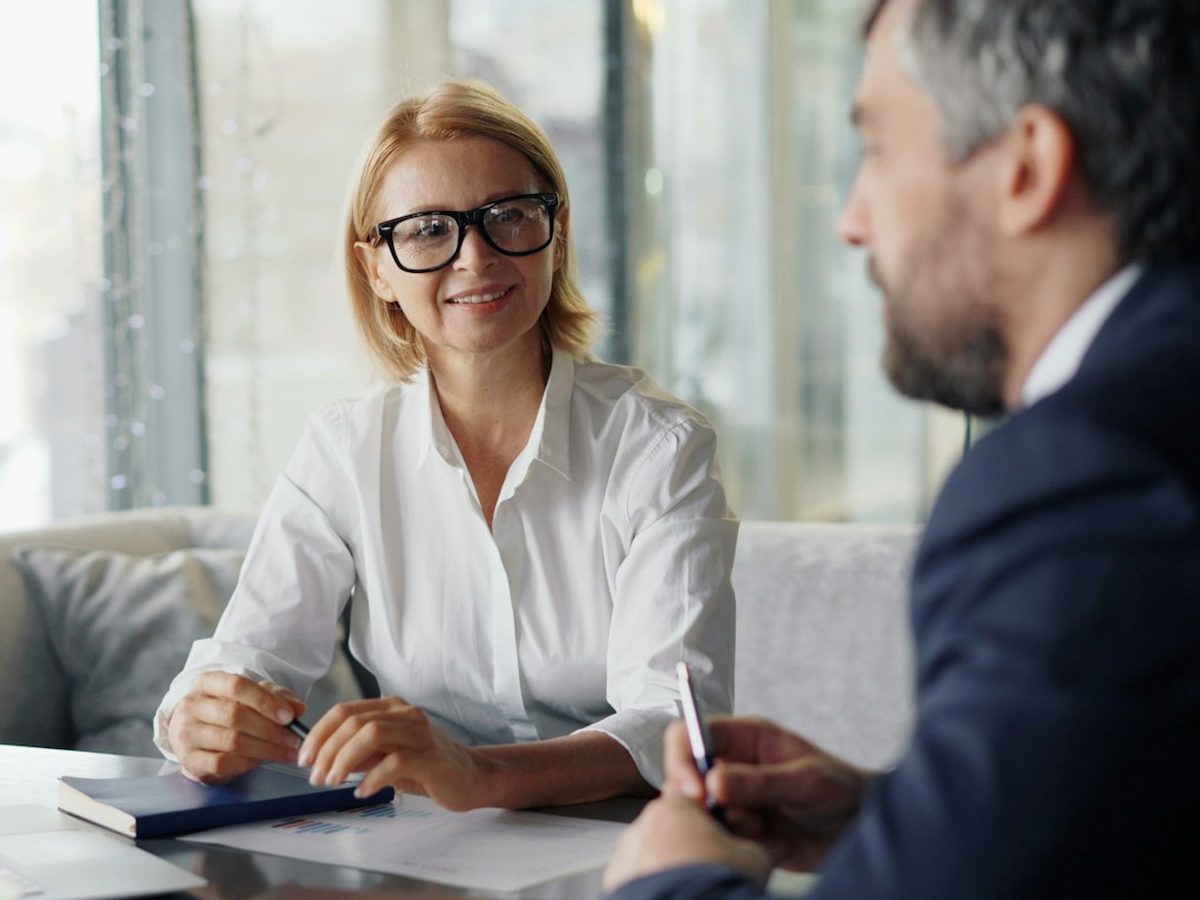 A member and an advisor talking through paperwork at a table